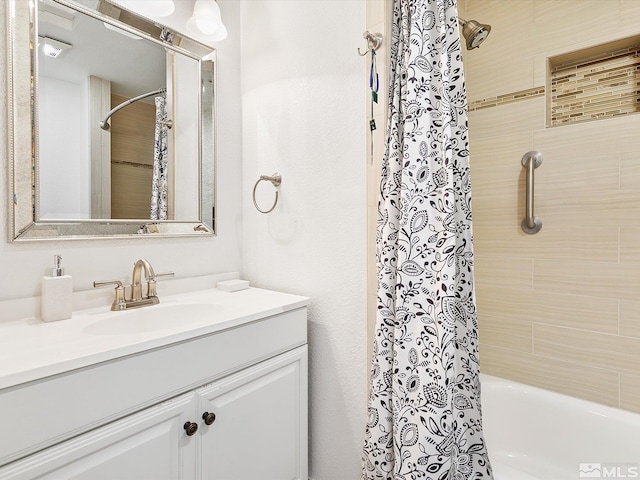 bathroom with shower / bath combo with shower curtain and vanity