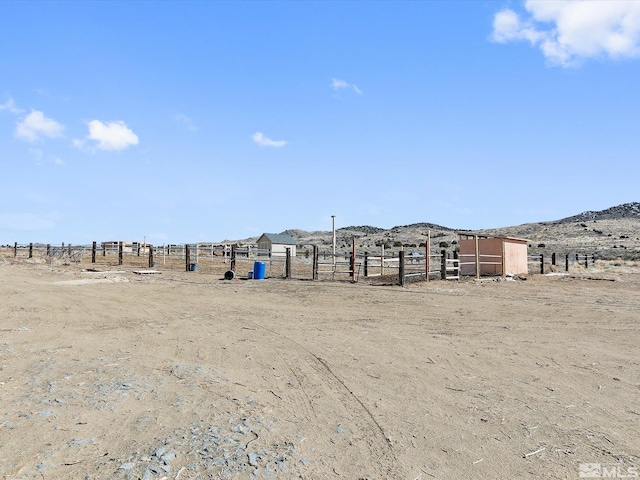 view of yard featuring a mountain view and a rural view