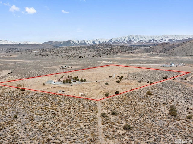 birds eye view of property with a mountain view