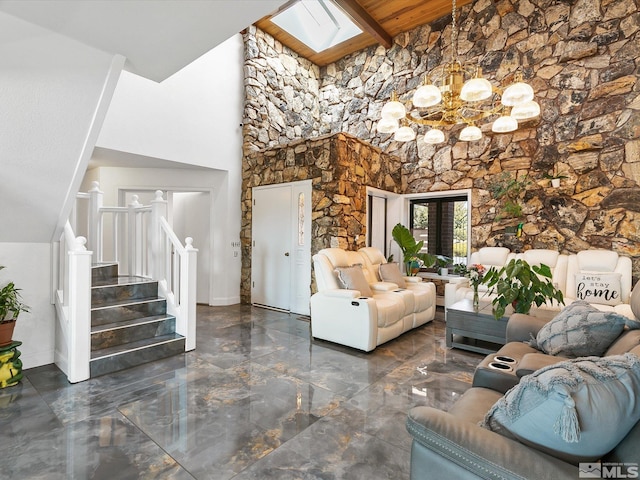 tiled living room featuring a notable chandelier, beamed ceiling, high vaulted ceiling, and a skylight