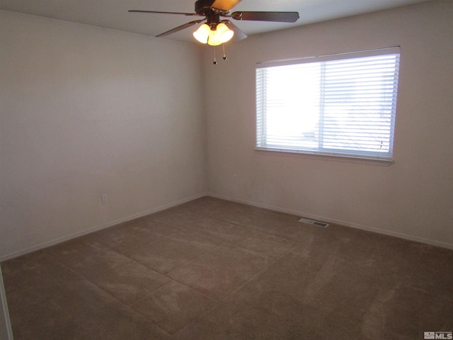 carpeted spare room with ceiling fan