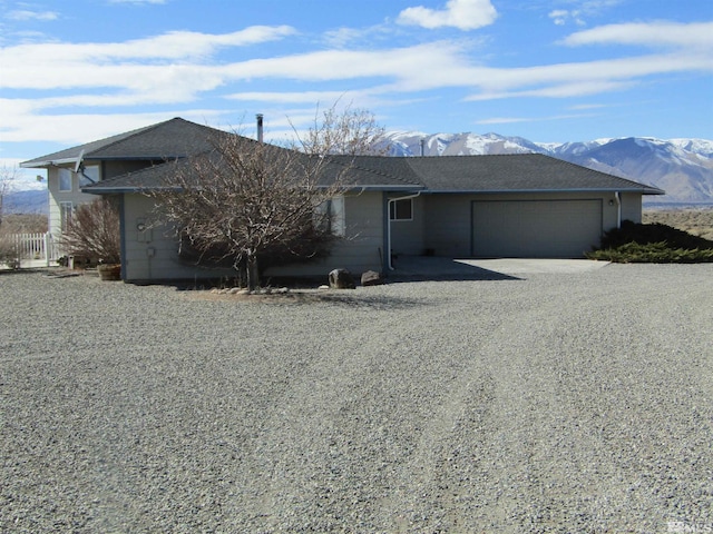 ranch-style house with a mountain view and a garage