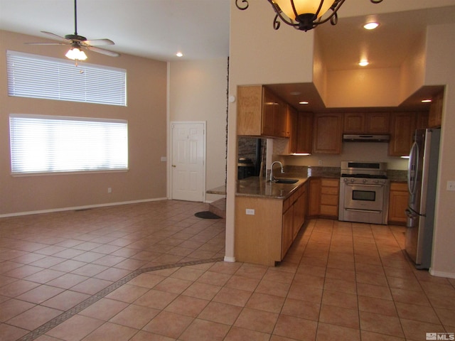 kitchen with stainless steel refrigerator, sink, light tile floors, and white stove