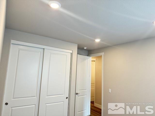 bedroom featuring hardwood / wood-style flooring and a closet