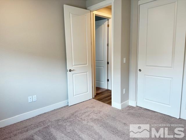 unfurnished bedroom featuring carpet flooring