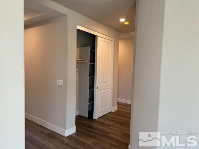 corridor featuring dark hardwood / wood-style flooring