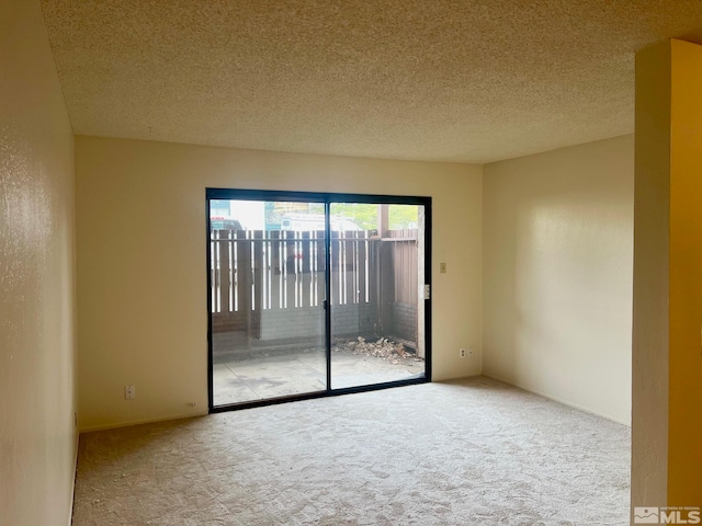 unfurnished room featuring carpet floors and a textured ceiling