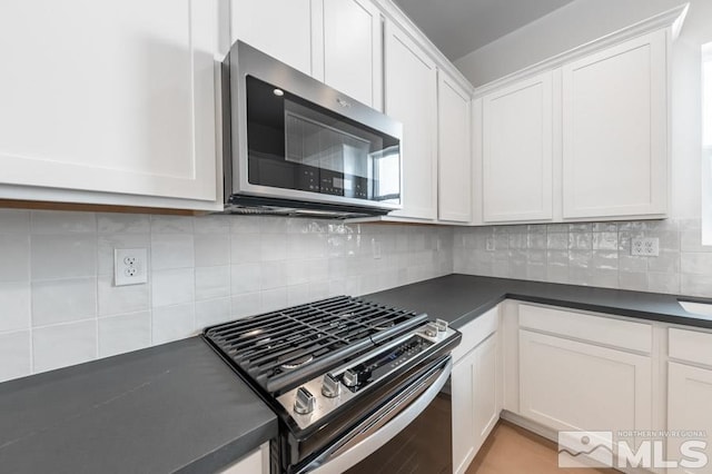 kitchen featuring white cabinetry, electric range, and tasteful backsplash