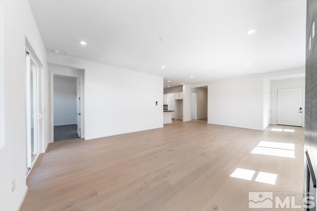 unfurnished living room with light hardwood / wood-style floors