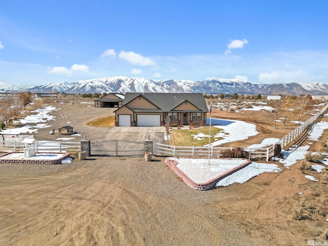 exterior space with a garage and a mountain view