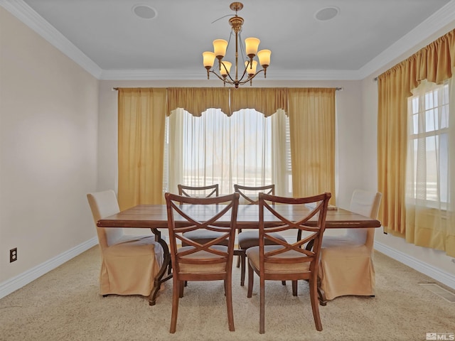 dining room with ornamental molding, light colored carpet, and an inviting chandelier