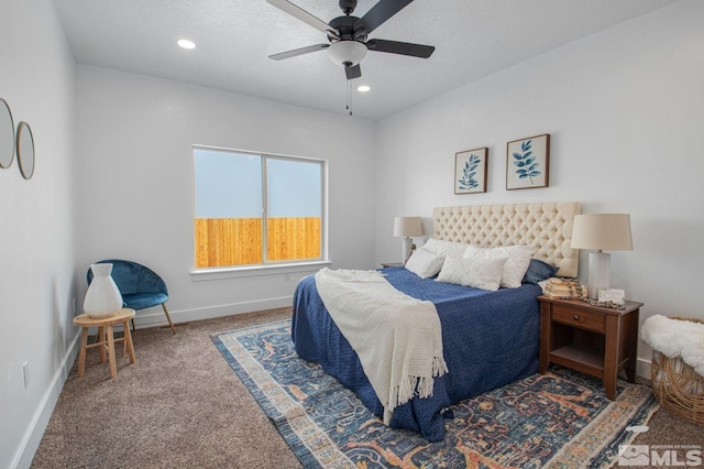 bedroom featuring ceiling fan and dark carpet