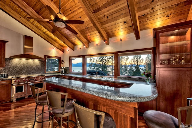 bar featuring dark stone countertops, double oven range, lofted ceiling with beams, wall chimney range hood, and wood ceiling