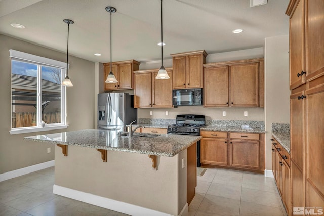 kitchen featuring a breakfast bar, sink, light stone countertops, and stainless steel fridge with ice dispenser