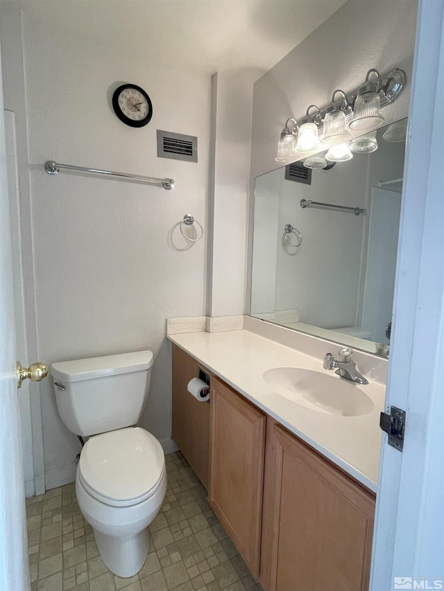 bathroom featuring toilet and vanity