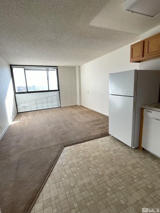 unfurnished living room featuring light carpet and a textured ceiling