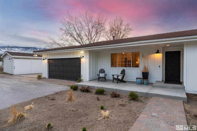 single story home featuring covered porch and a garage