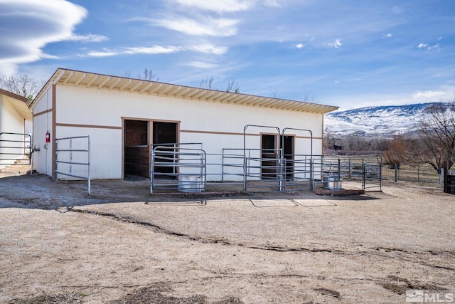 view of stable featuring an outdoor structure and a mountain view