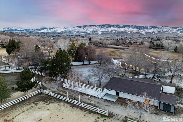 aerial view at dusk featuring a mountain view