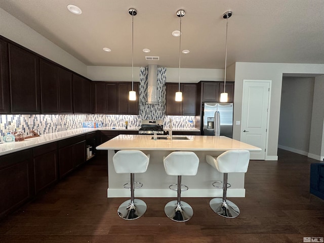 kitchen with decorative light fixtures, stove, tasteful backsplash, stainless steel refrigerator with ice dispenser, and dark hardwood / wood-style flooring