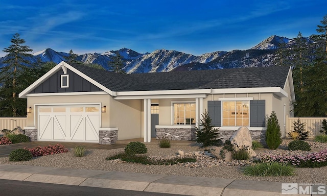 view of front of house featuring a mountain view, a garage, stone siding, concrete driveway, and roof with shingles