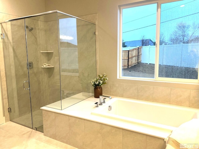 full bathroom with a garden tub and a shower stall