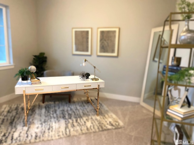 carpeted office featuring baseboards