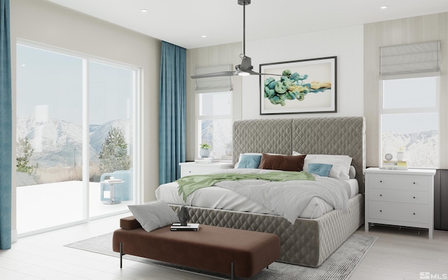 bedroom featuring light wood-type flooring, access to exterior, a mountain view, and recessed lighting