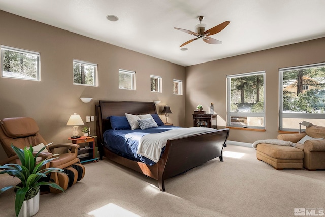 bedroom with ceiling fan and light carpet