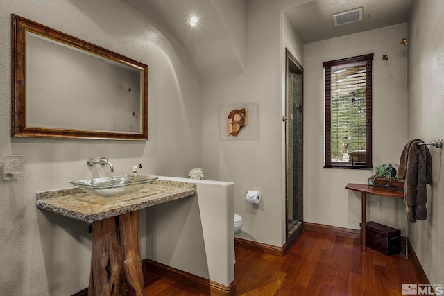 bathroom with toilet, vanity, walk in shower, and hardwood / wood-style flooring