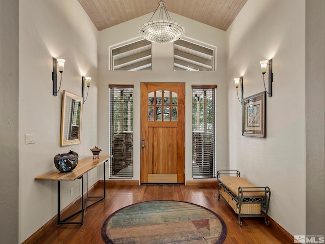 foyer featuring plenty of natural light, dark hardwood / wood-style flooring, and lofted ceiling