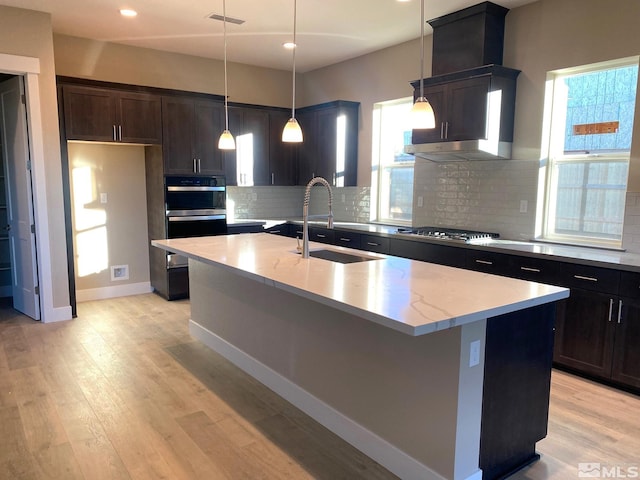 kitchen with visible vents, a sink, light wood-type flooring, stainless steel gas cooktop, and a wealth of natural light