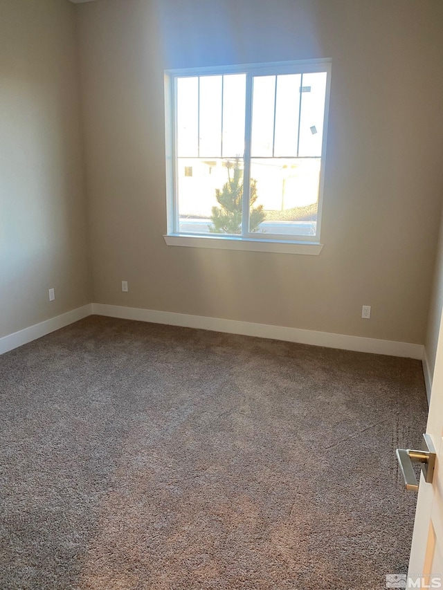 empty room with carpet floors and baseboards