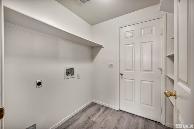 washroom featuring hardwood / wood-style flooring, washer hookup, and hookup for an electric dryer