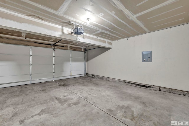 garage with a garage door opener and electric panel