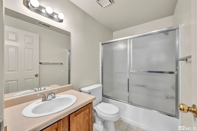 full bathroom with toilet, bath / shower combo with glass door, and vanity