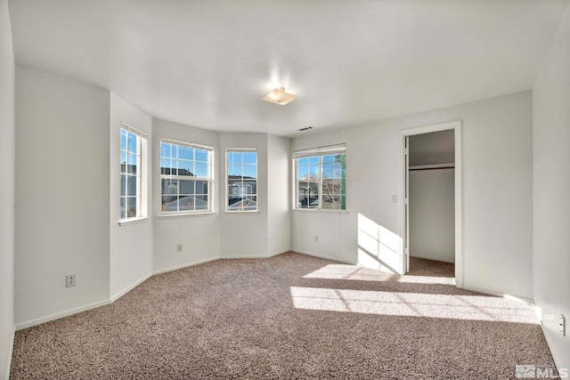 unfurnished bedroom featuring light carpet