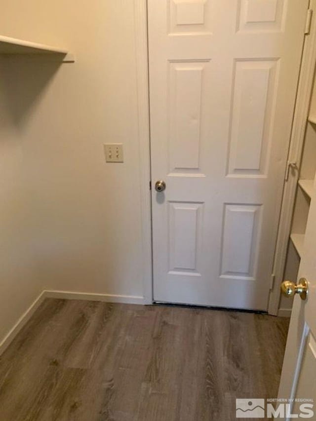 clothes washing area featuring dark hardwood / wood-style flooring