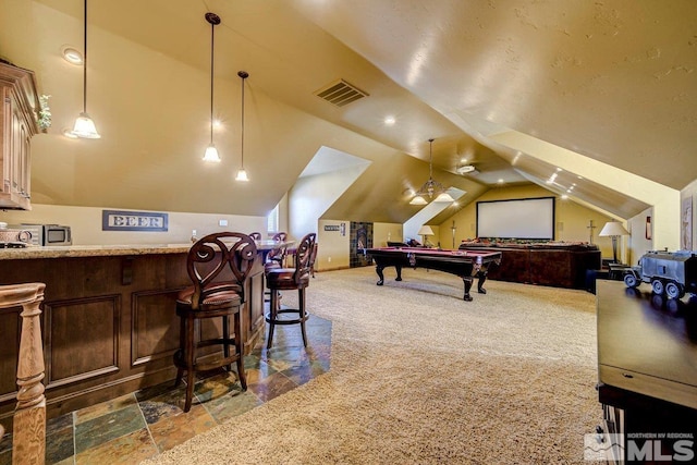 interior space featuring billiards, vaulted ceiling, and dark carpet