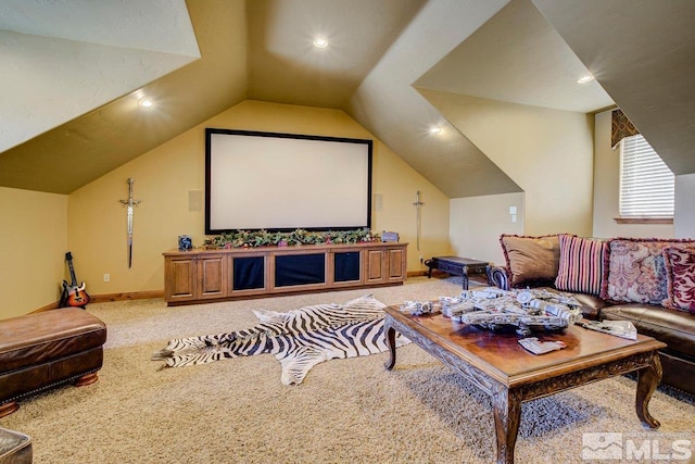 carpeted home theater room featuring vaulted ceiling