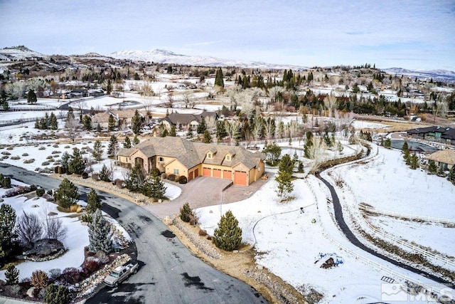 snowy aerial view with a mountain view