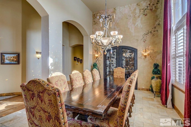 dining room with an inviting chandelier and light tile floors