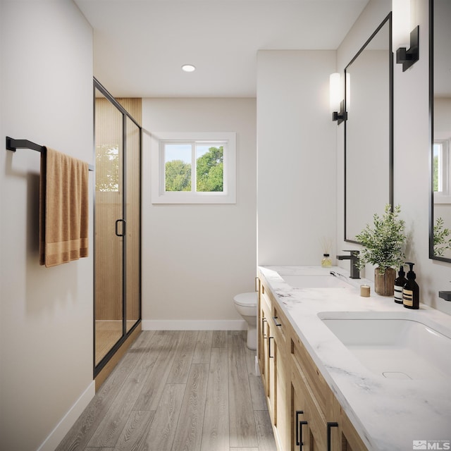 bathroom with an enclosed shower, toilet, double vanity, and wood-type flooring