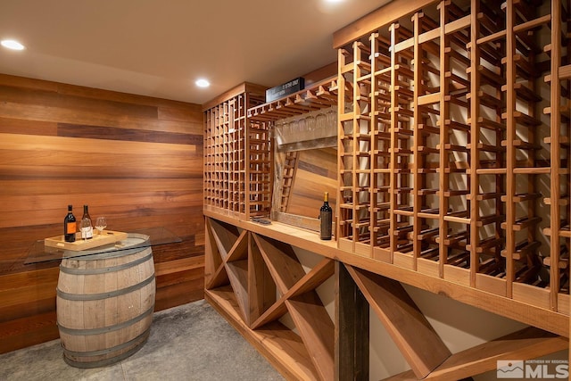 wine cellar featuring wood walls and indoor bar