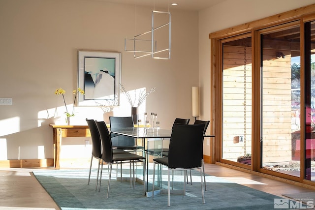 dining space with light hardwood / wood-style floors