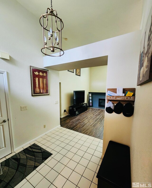 living room featuring a notable chandelier and tile floors