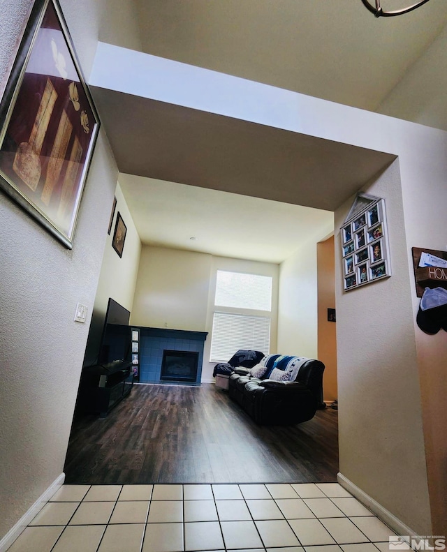 living room featuring a fireplace and tile flooring