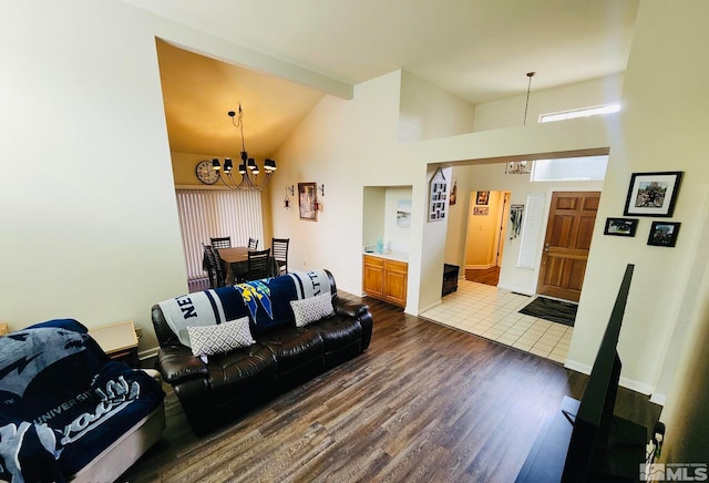 living room with beamed ceiling, a notable chandelier, high vaulted ceiling, and dark hardwood / wood-style flooring