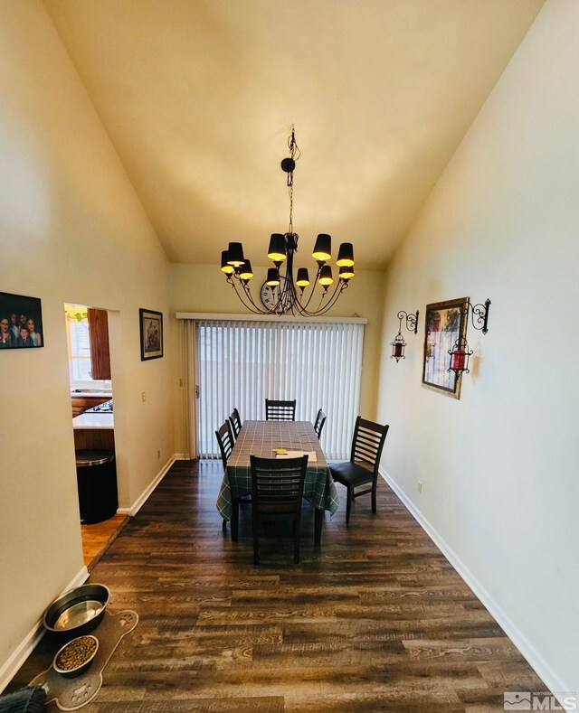 dining space with dark hardwood / wood-style flooring, an inviting chandelier, and high vaulted ceiling