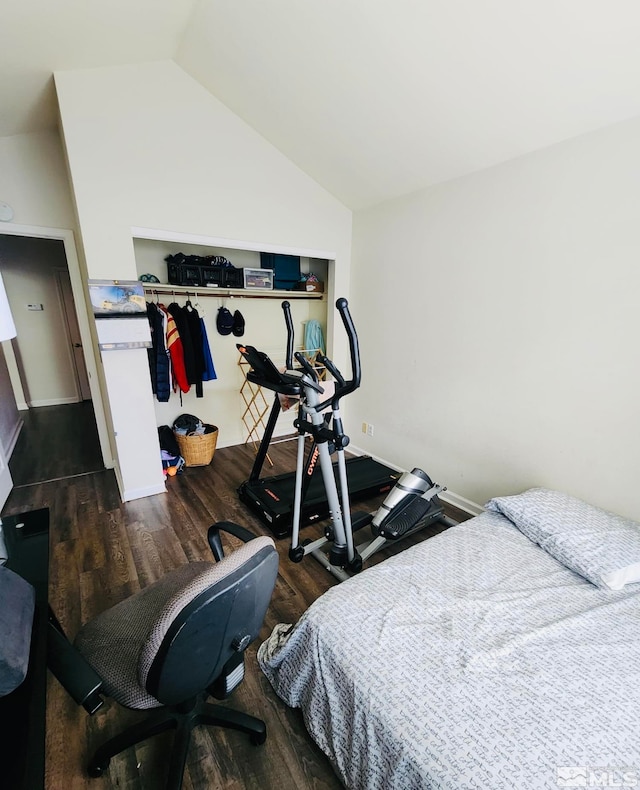 bedroom with lofted ceiling, a closet, and dark hardwood / wood-style flooring